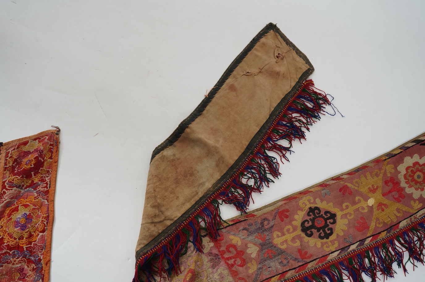 Five various sized late 19th / early 20th century Usbek Saye Gosha (V shaped) Suzani silk embroidered bridal yurt wall hangings, usually forming part of a dowry, two with later fringing, longest 172cm. Condition - some f
